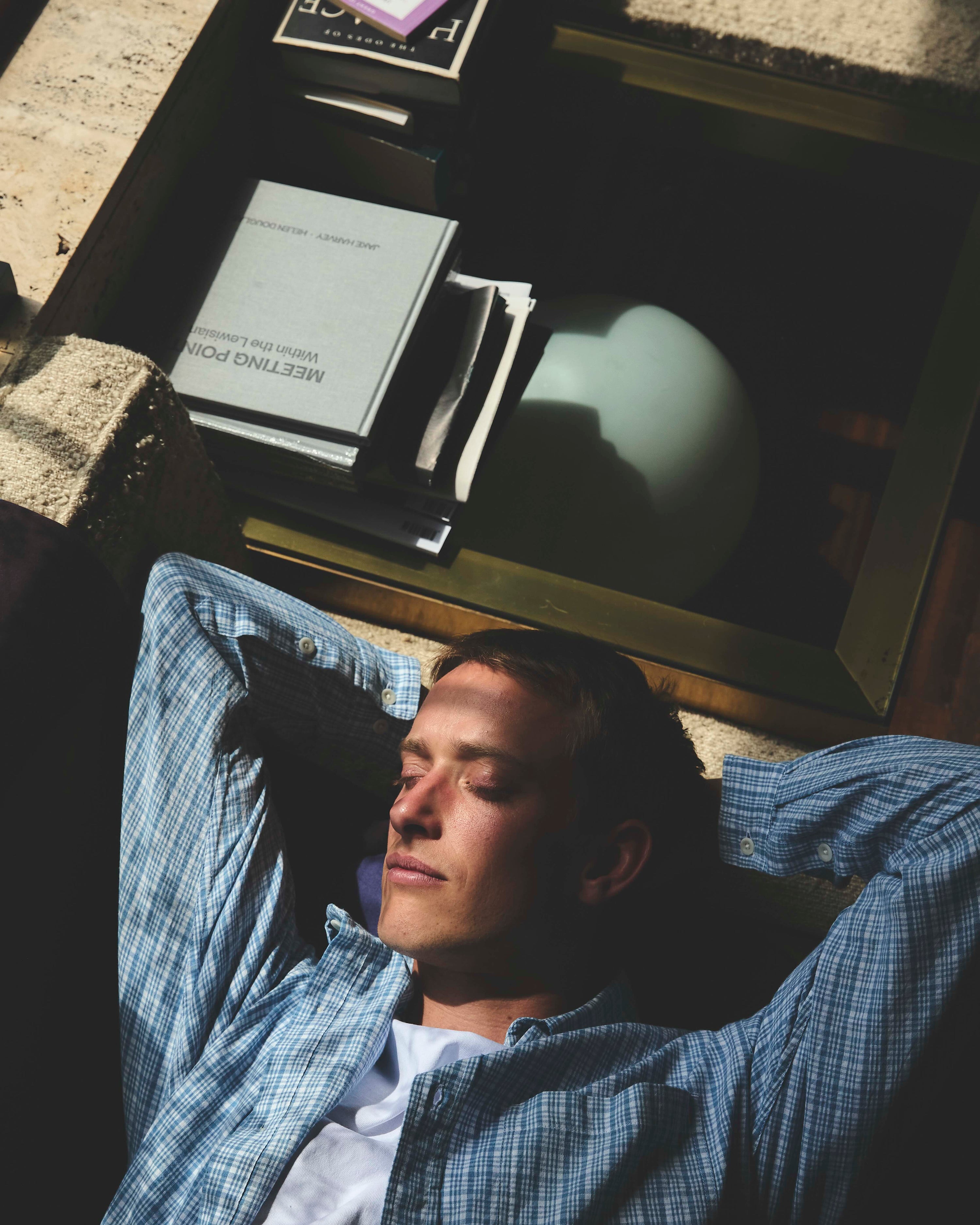 A man lay down in a checked shirt