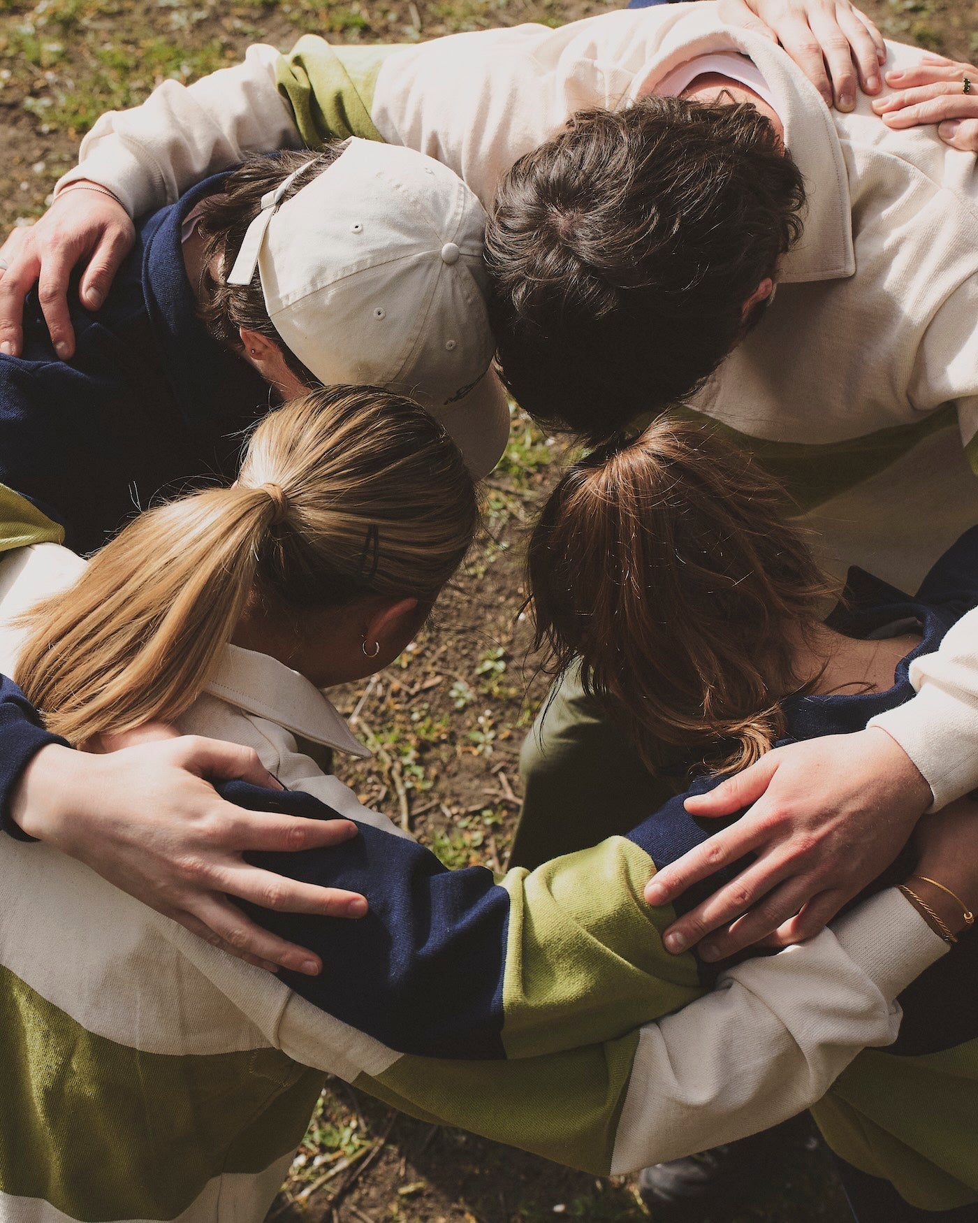 people in huddle wearing rugby shirts